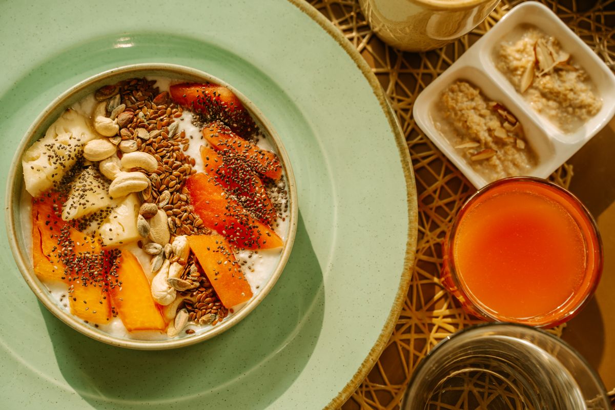 A healthy breakfast bowl with yogurt, fruit, and seeds